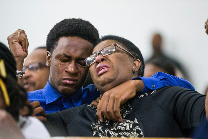 Allison Jean was held by her son Grant, 15, during a prayer service for her son and Grant's...