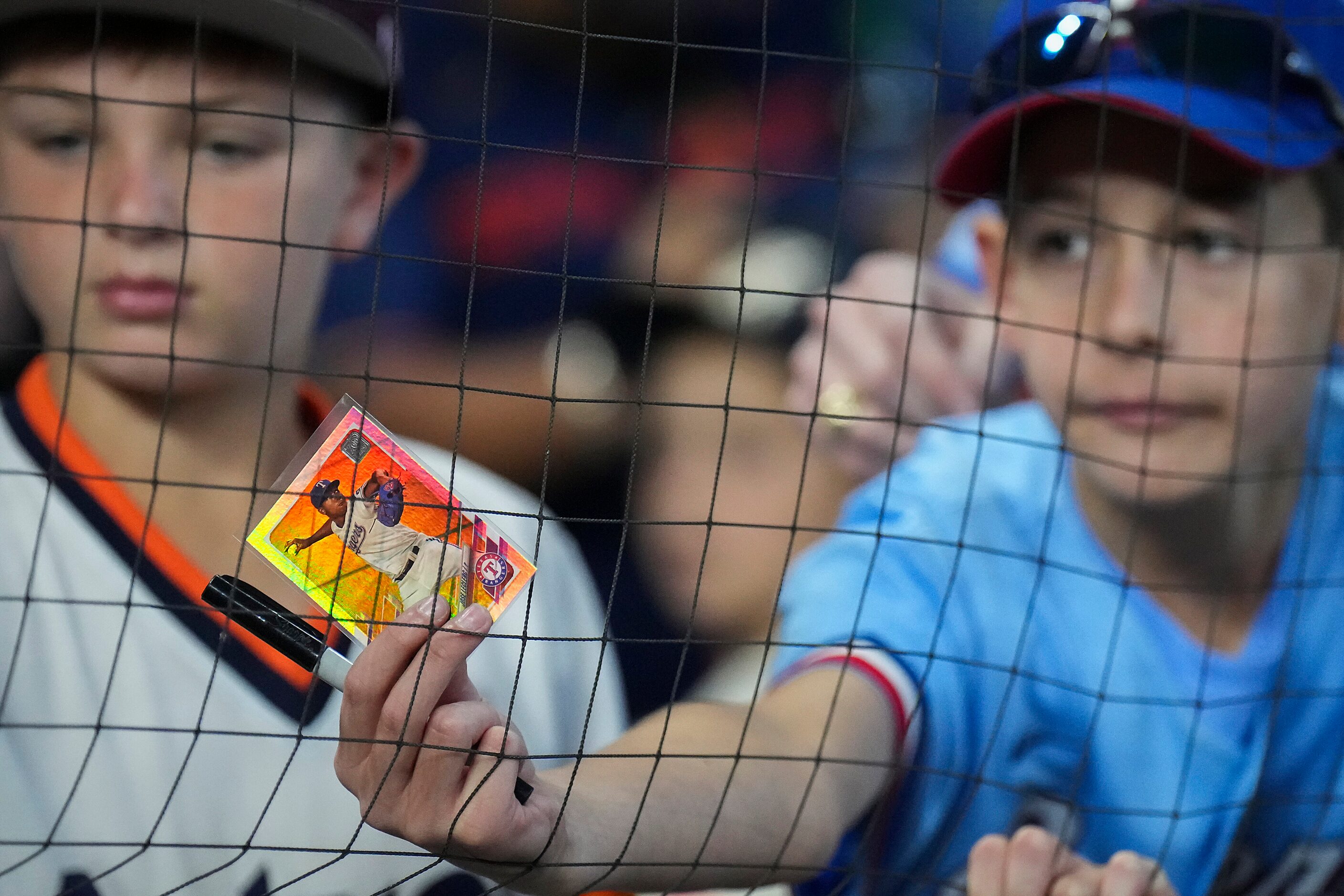 Fans look for an autograph from Texas Rangers relief pitcher Jose Leclerc before Game 2 of...