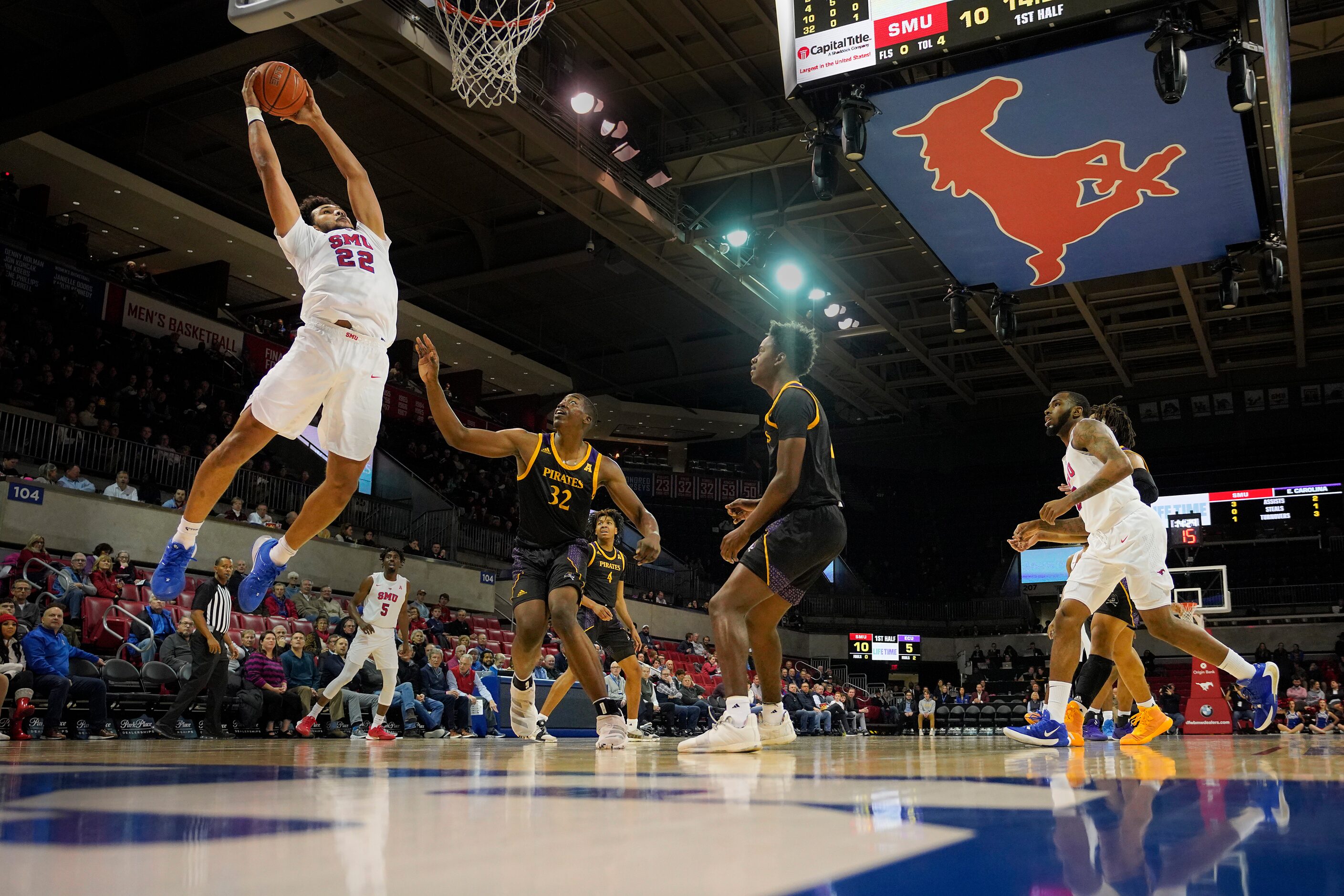 SMU forward Isiah Jasey (22) goes up for a dunk over East Carolina center Charles Coleman...