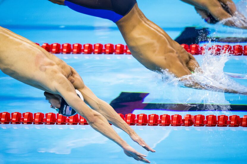 Michael Phelps dives into the pool for the men's 200m butterfly final at the Rio 2016...