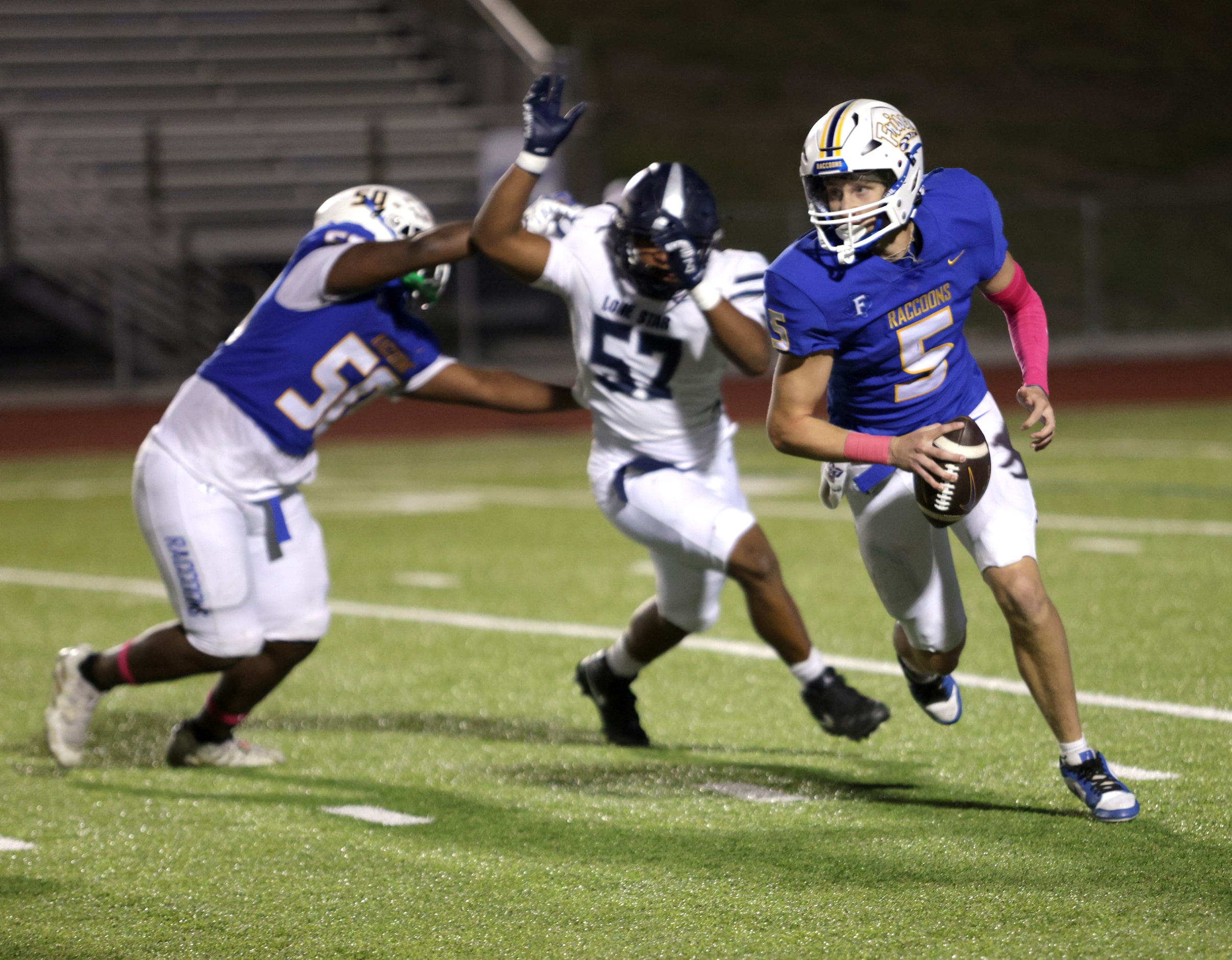 Frisco player #5 Cobyn Harbert looks for a open receiver as he tries to avoid being tackled...