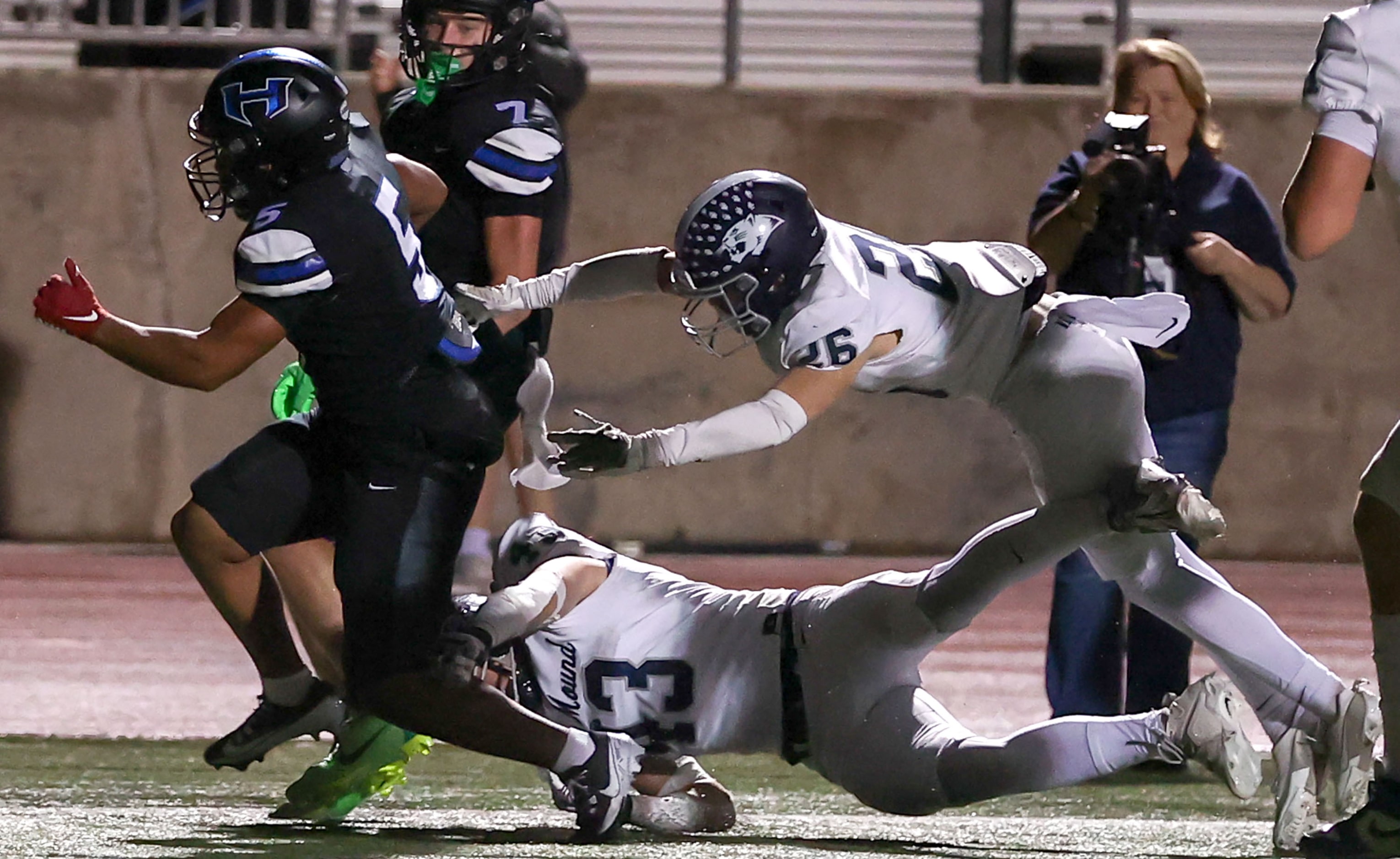 Hebron running back Ayson McCray Jones (5) avoids Flower Mound safety Silas Wilson (13) and...