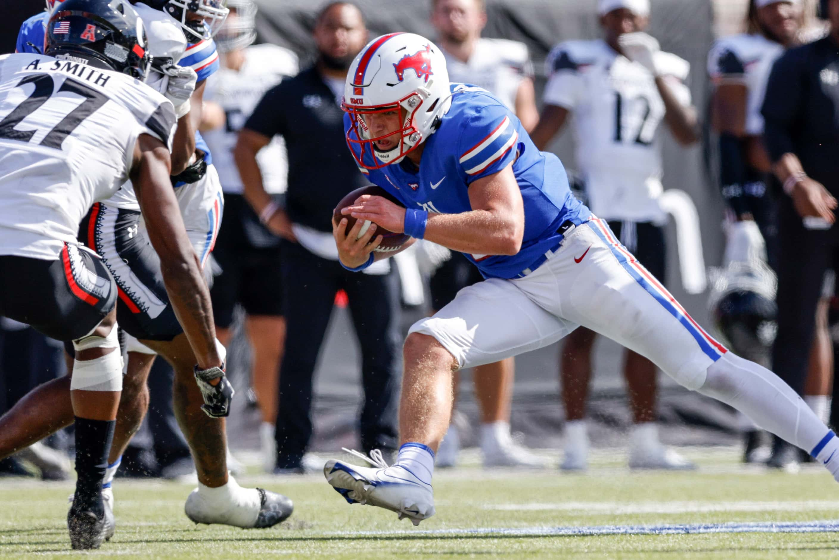 SMU quarterback Preston Stone (2) dives forward after a run towards Cincinnati safety...