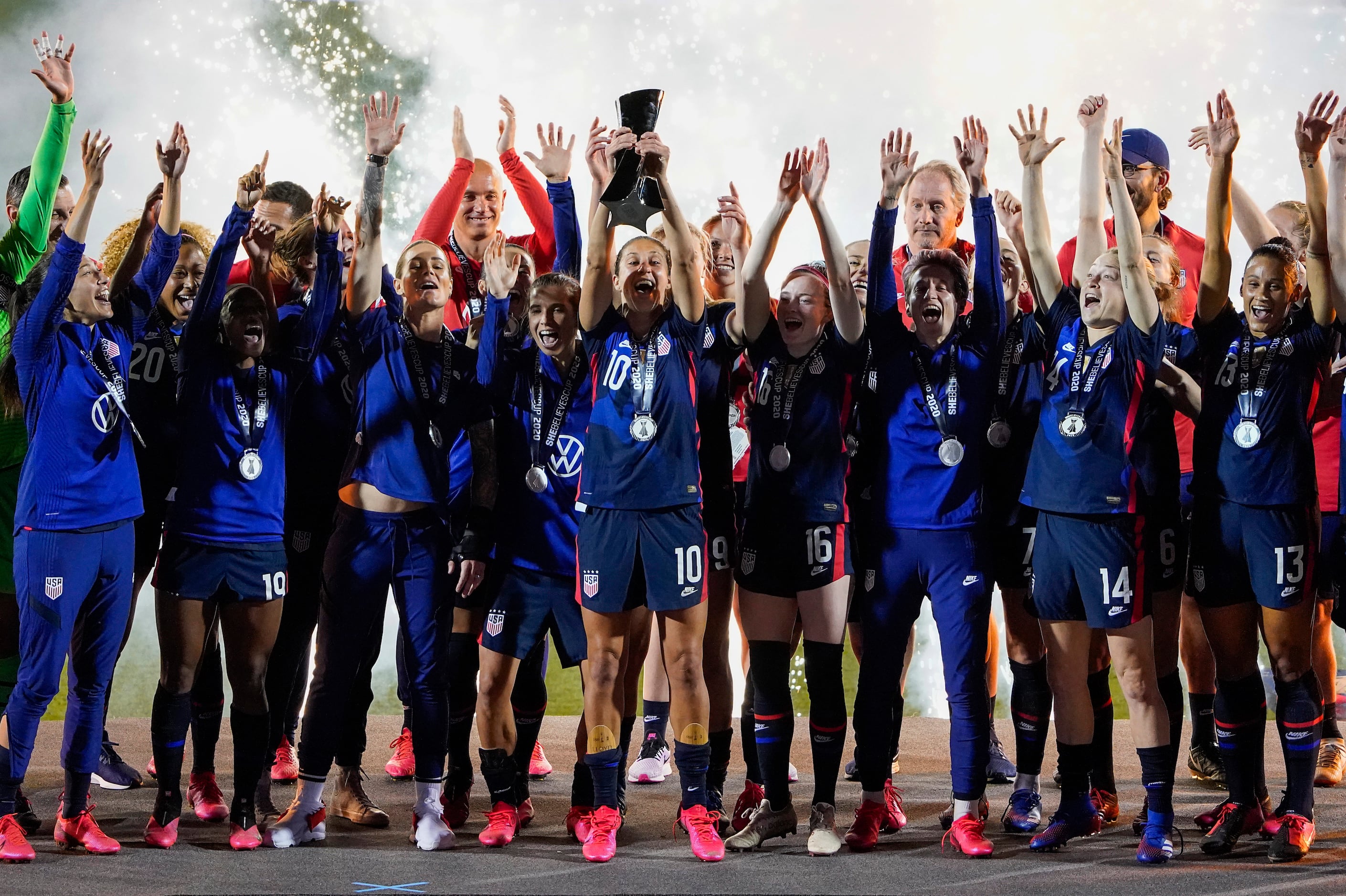 USA forward Carli Lloyd (10) lifts the trophy after a victory over Japan in a SheBelieves...