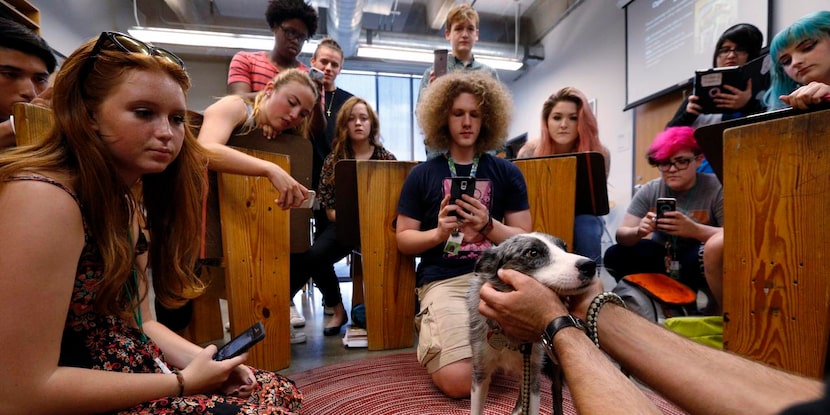 
Booker T. Washington visual art students gather to take photos of Candy the dog.
