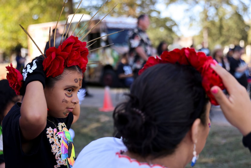 Zavannah Orozco, 7, follows her cousin Erica Solis as she put on a headband during Day of...