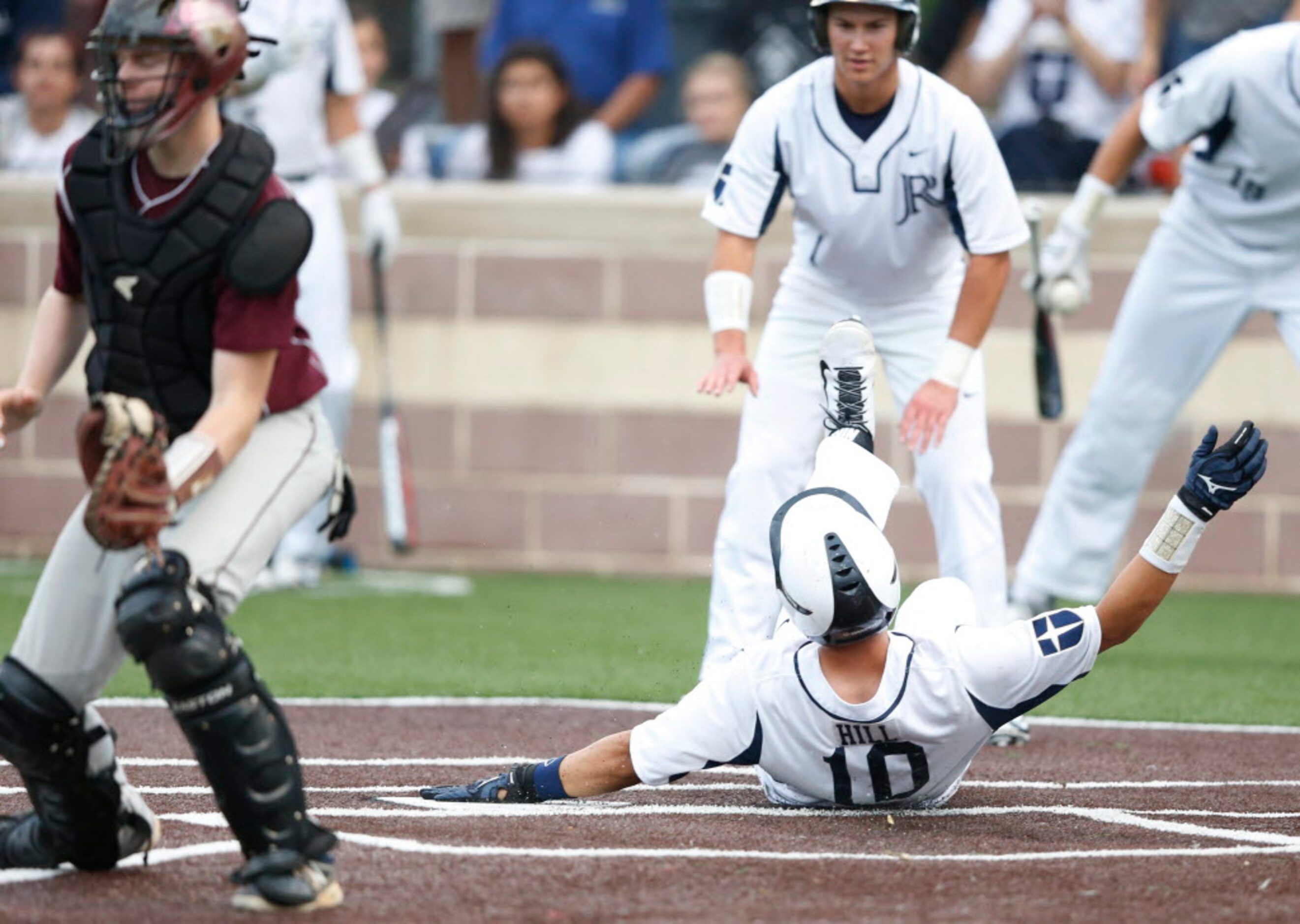 Jesuit's Darius Hill (10) safely slides into home for a run in a game against Mesquite High...