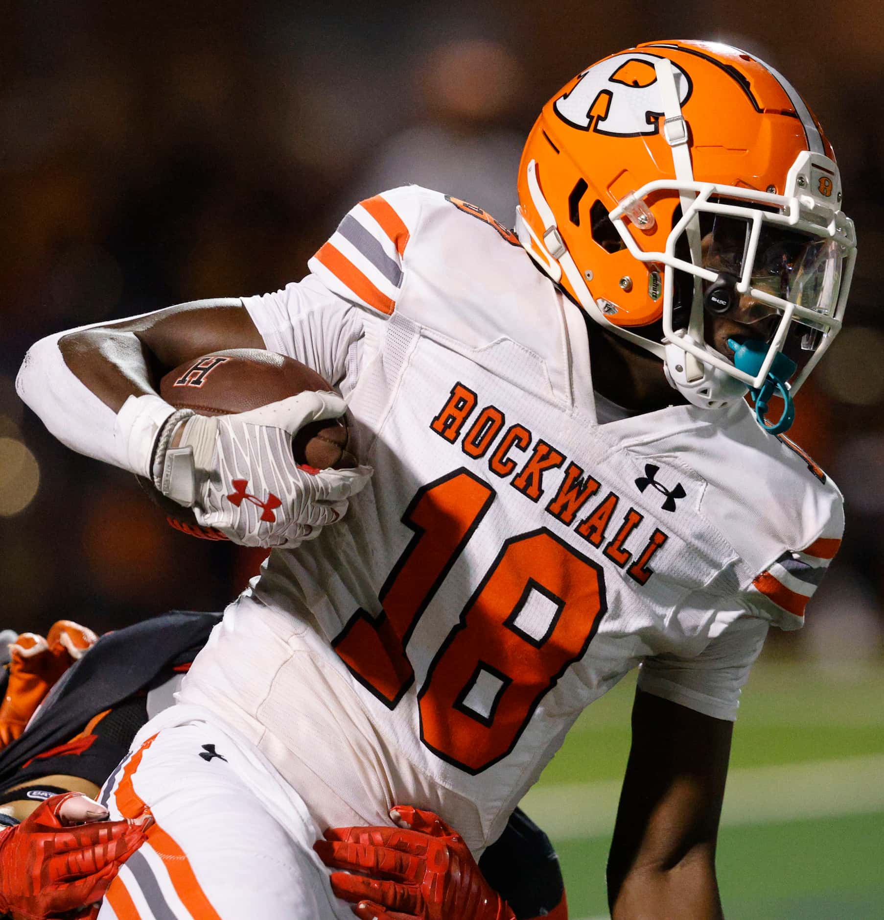 Rockwall's Matthew Young (18) carries the ball against Rockwall-Heath during the first half...