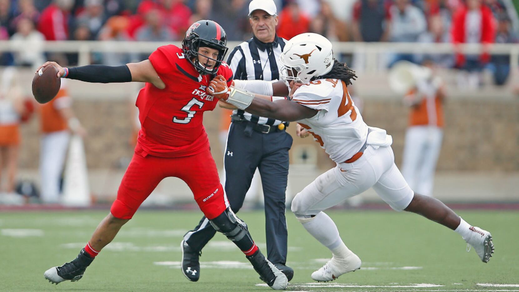 Texas Tech's Patrick Mahomes (5) tries to avoid being sacked by Texas' Malik Jefferson (46)...
