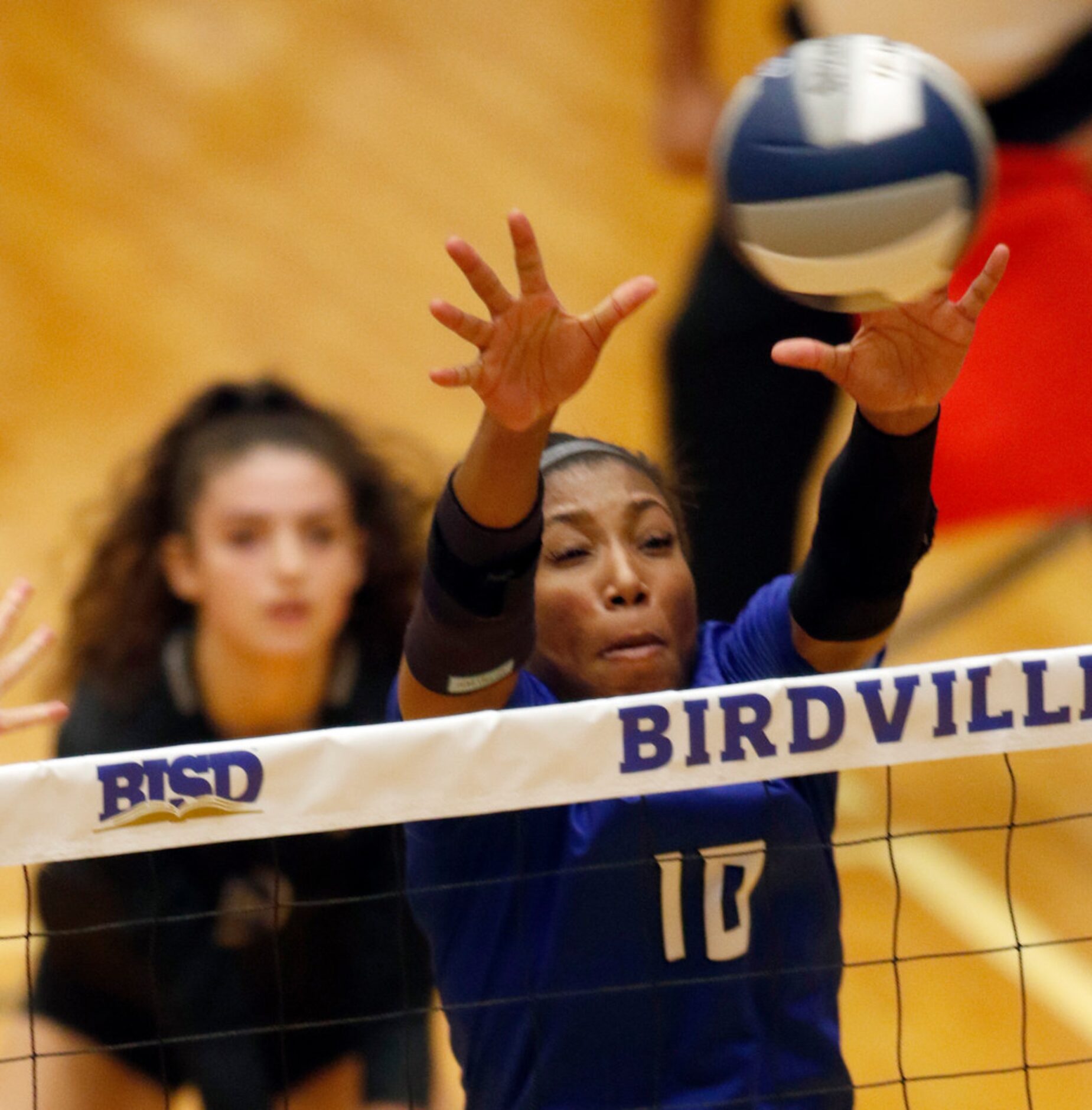 Trophy Club Byron Nelson outside hitter Charitie Luper (10) leaps to block a shot by a...