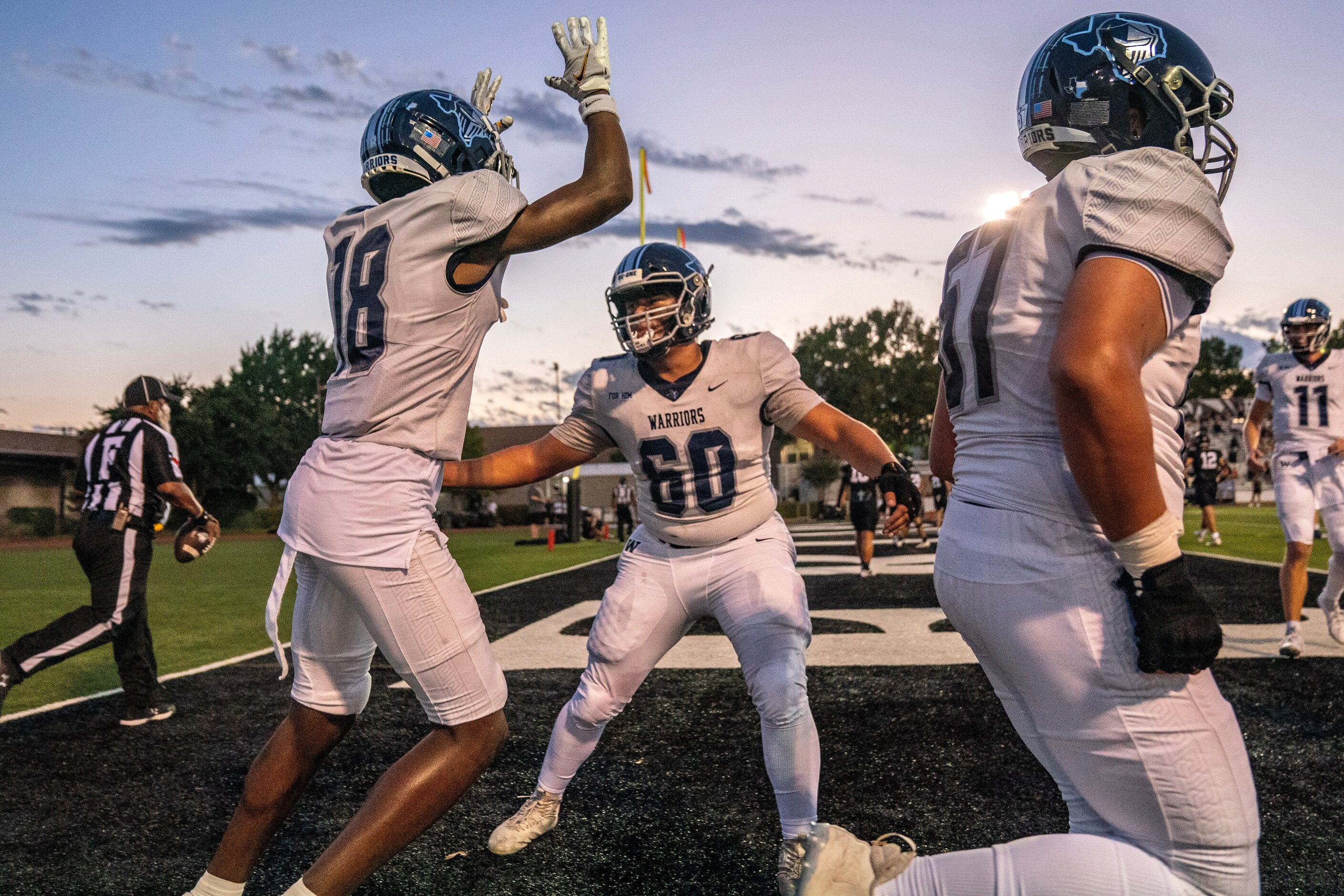 Argyle Liberty Christian senior offensive lineman Antonio Simone (60) congratulates junior...