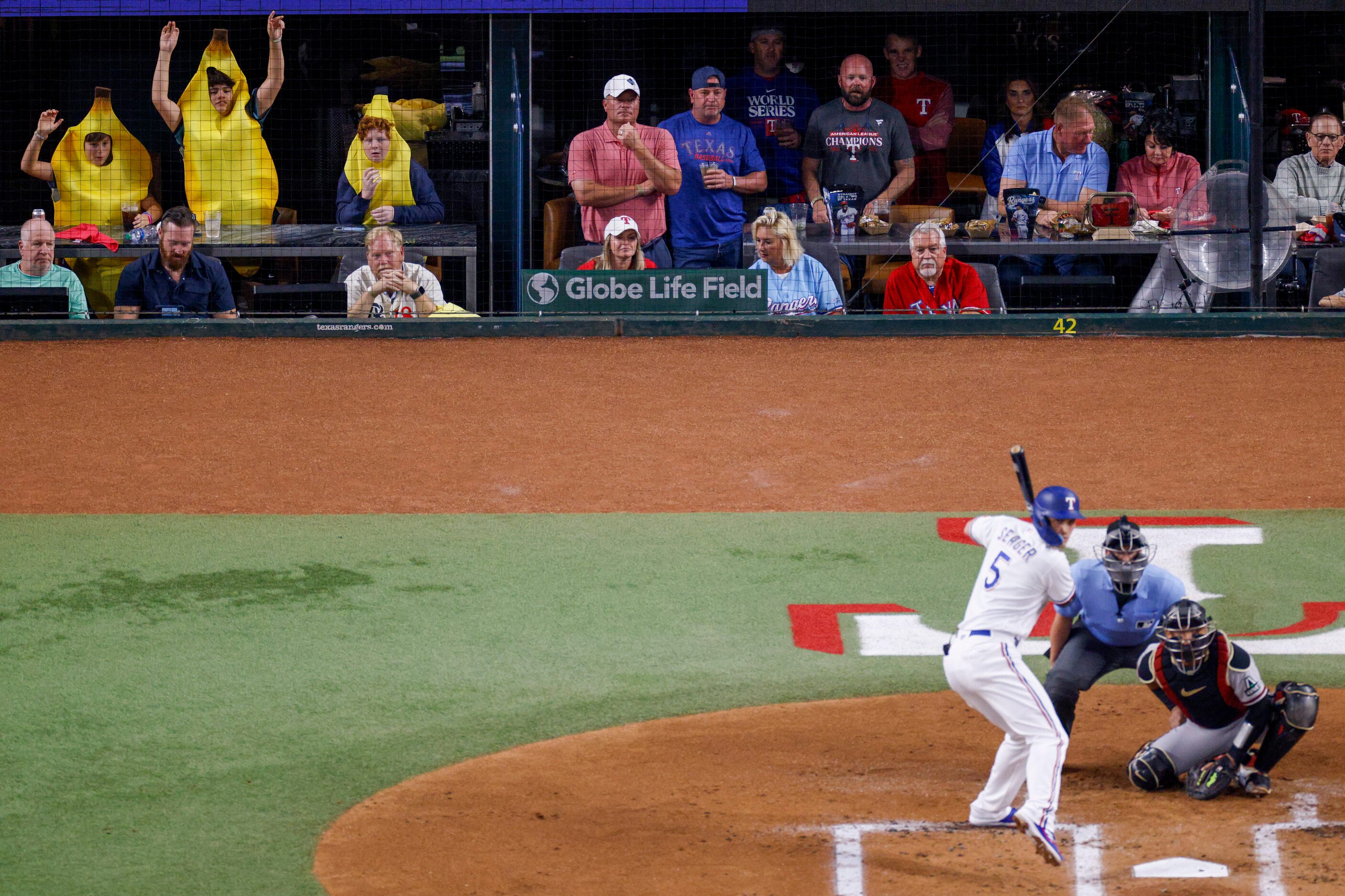 Three fans wearing banana suits try to distract Arizona Diamondbacks starting pitcher...