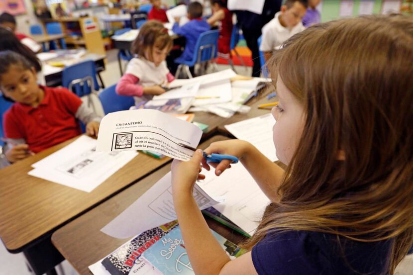 
First-grader Mayzie Alton works on a Spanish assignment in her two-way dual-language class...