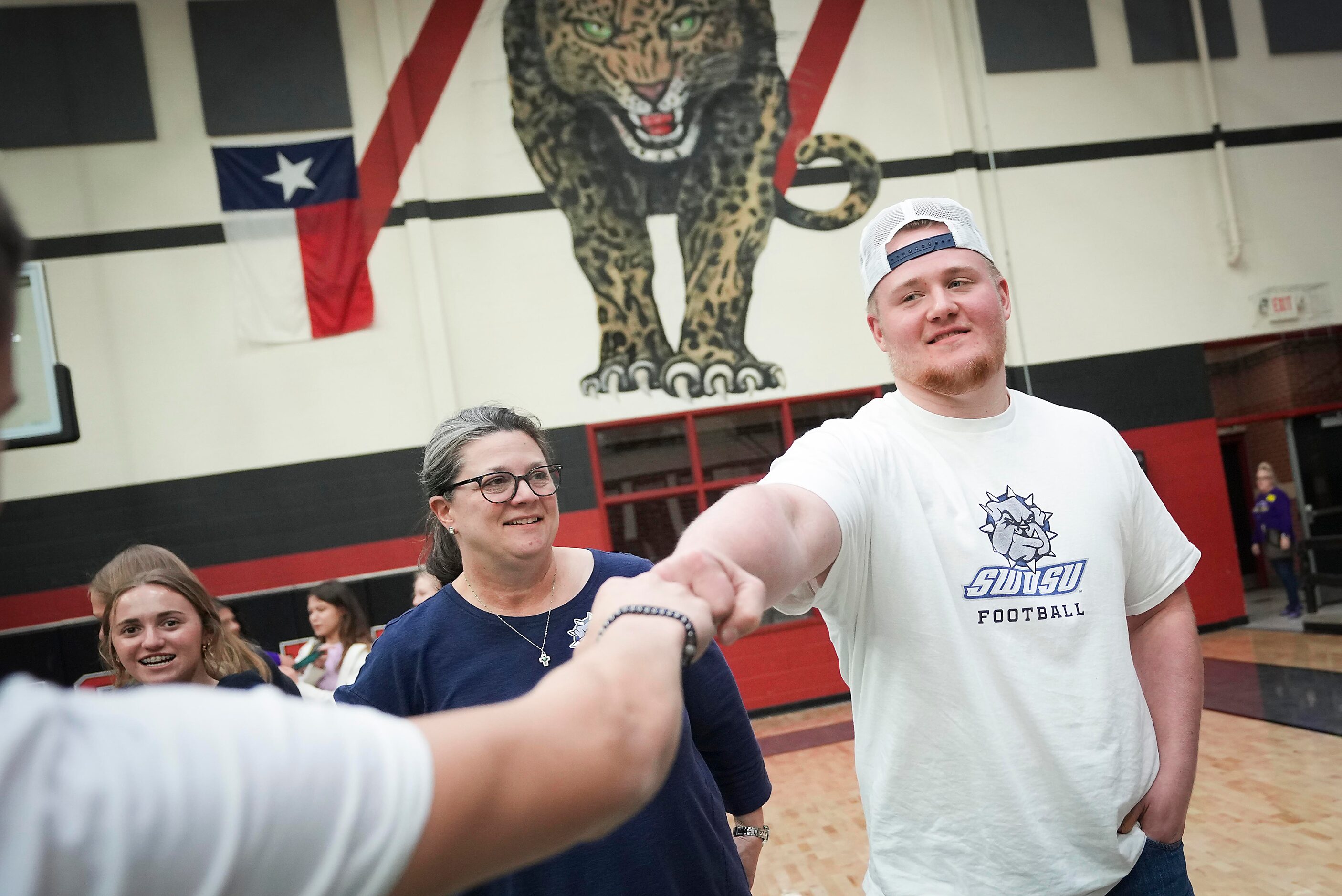 Lovejoy all-state offensive lineman Sam Reynolds is congratulated during a signing ceremony...