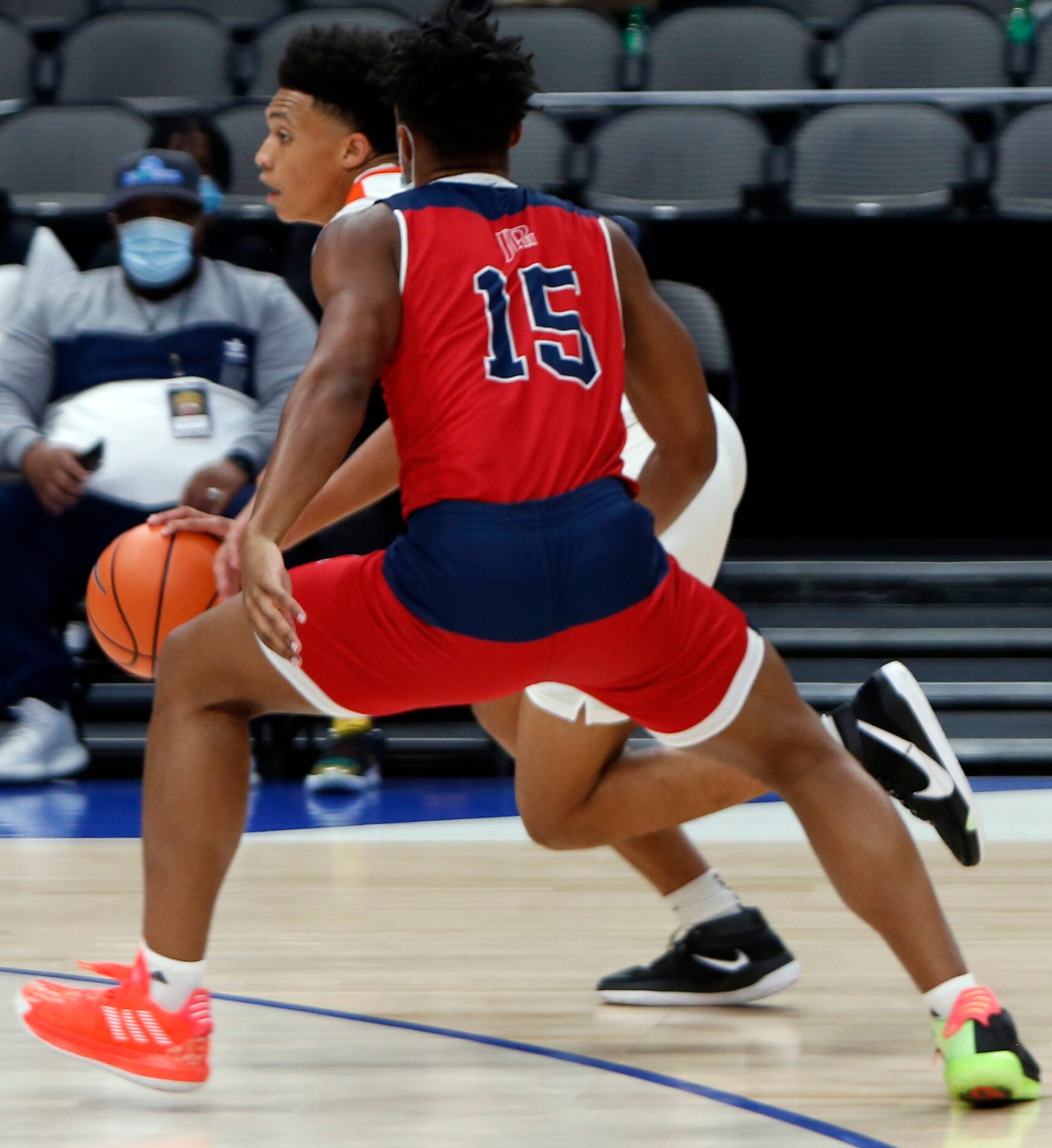 Lancaster's Elijah Hughey (5) drives the ball down the court past the defense of Plano John...