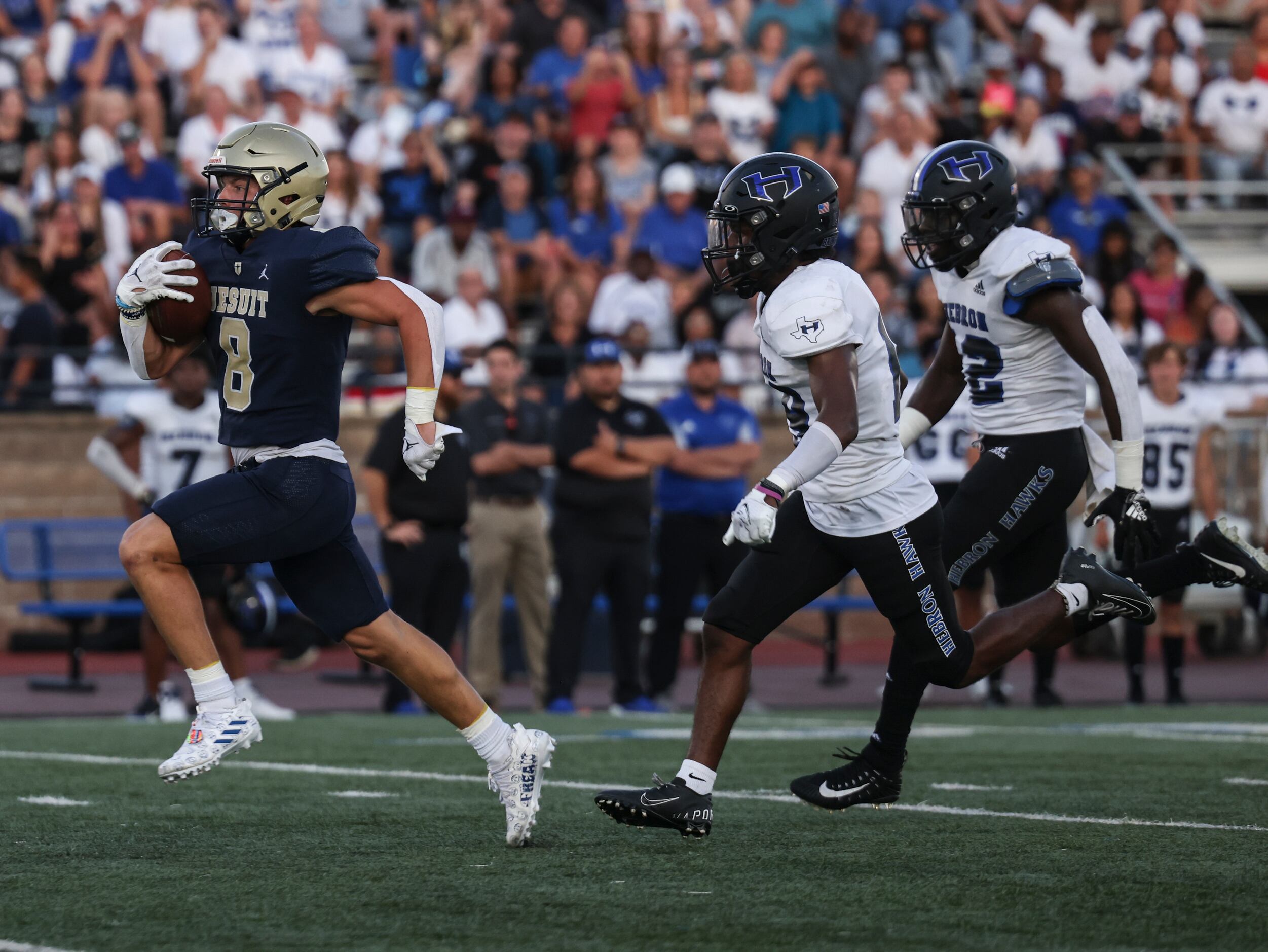 Jesuit Dallas Reed Pfaffenberger (8) runs the ball up the field as Hebron High School...