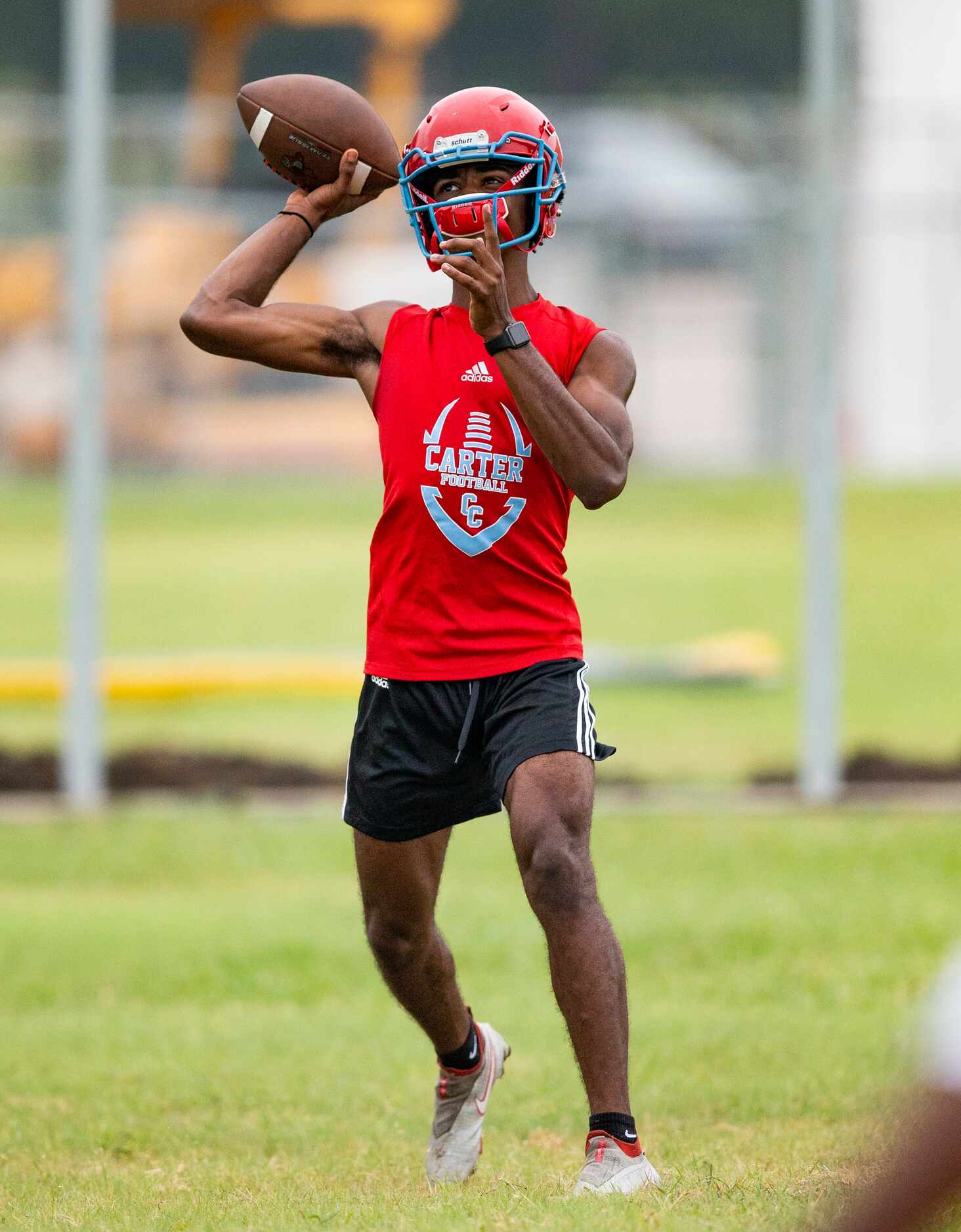 Carter senior quarterback William Young throws during the first day of football practice at...