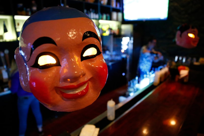 Clay masks hang from the bar at Hot Joy.  