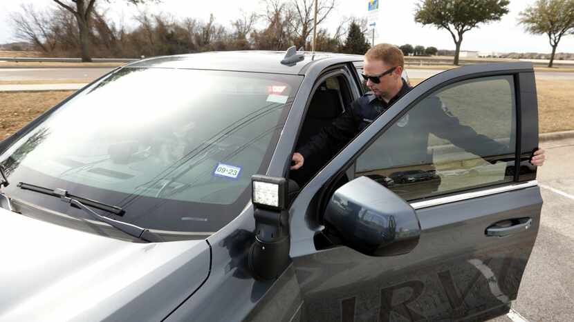 Irving police Officer Brien Wargacki climbs into a police cruiser, which is designed to...