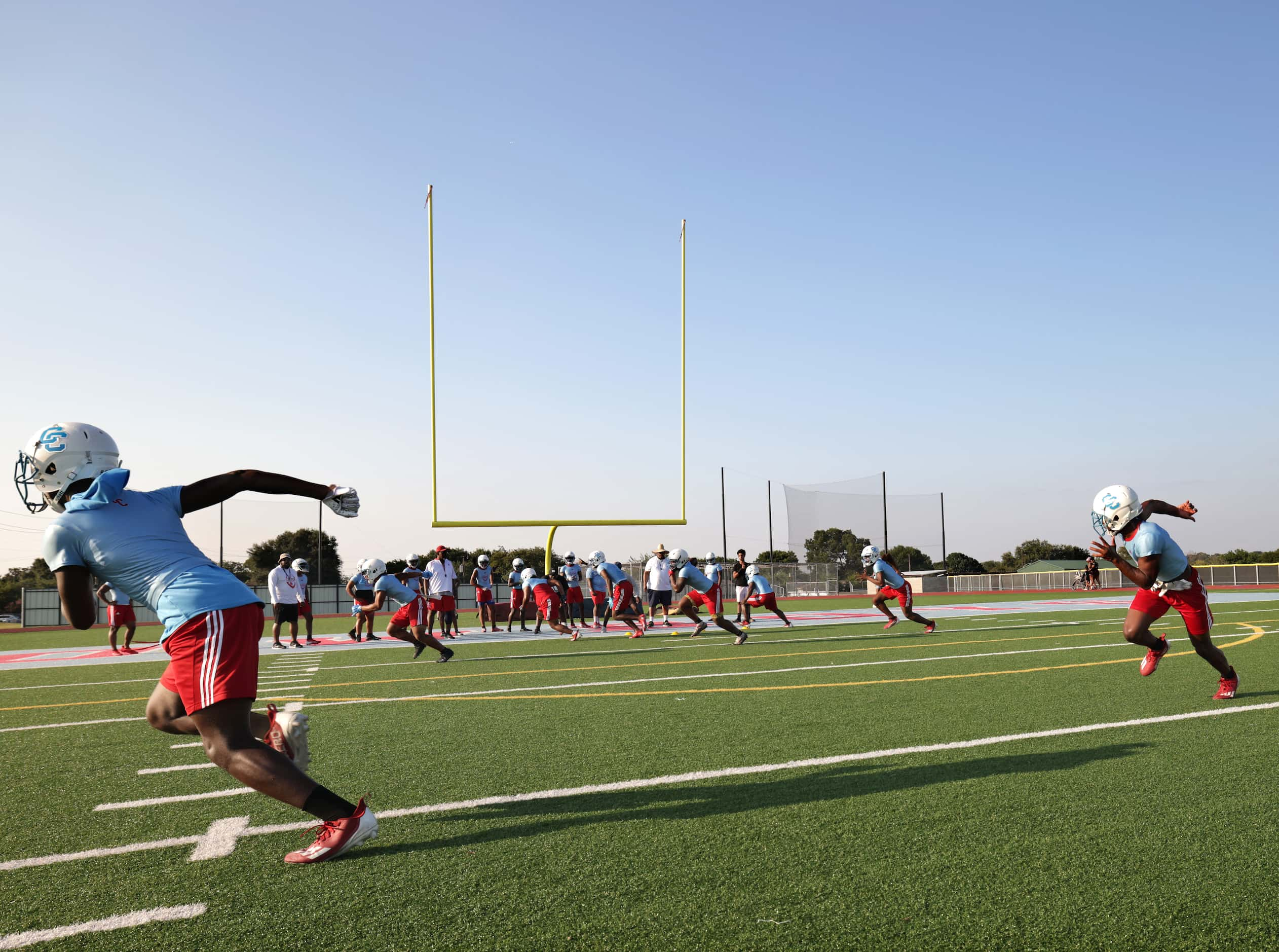 Players attend their first day of football practice at Carter High School in Dallas, TX, on...