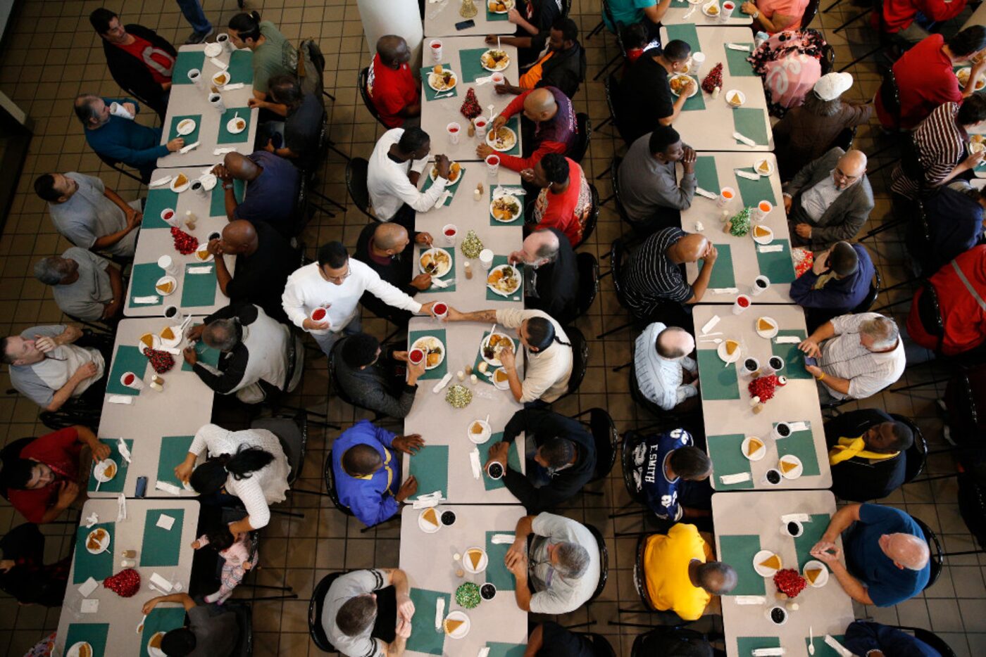 Volunteers hand out food during the Christmas meal served by the Salvation Army at the...