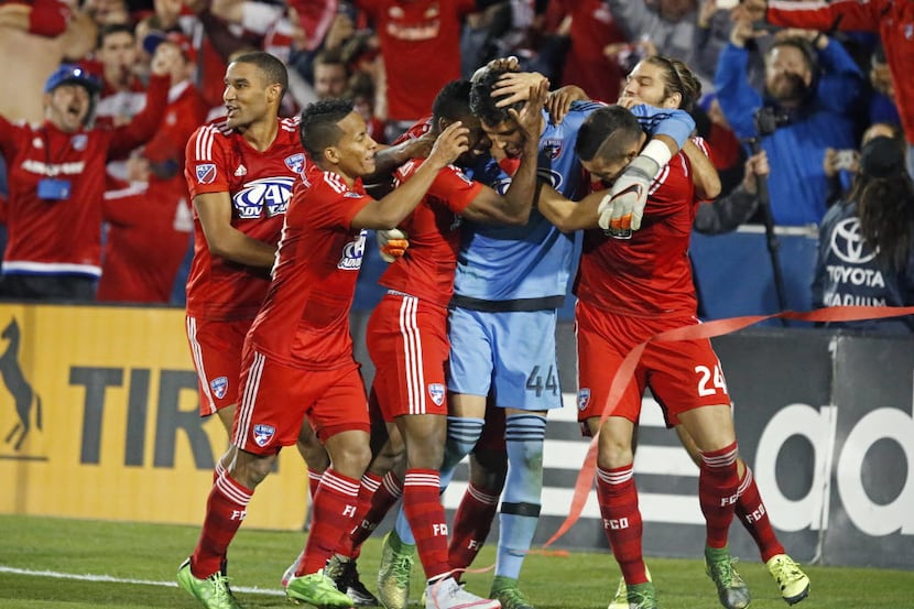 FC Dallas goalkeeper Jesse Gonzalez (44) is mobbed by team mates after he they won a shoot...