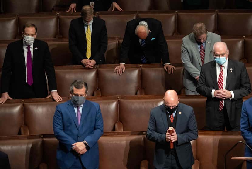 Sen. Ted Cruz and other members of Congress pray after Vice President Mike Pence declared...