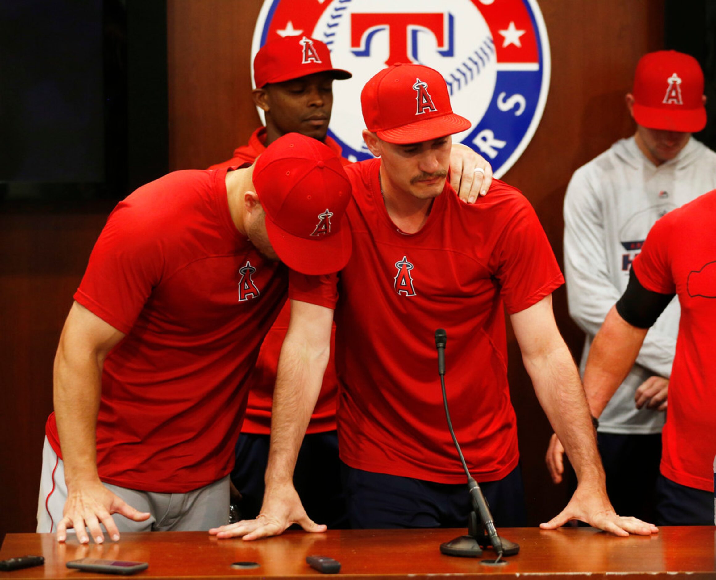 Los Angeles Angels center fielder Mike Trout (27) consoles Los Angeles Angels starting...