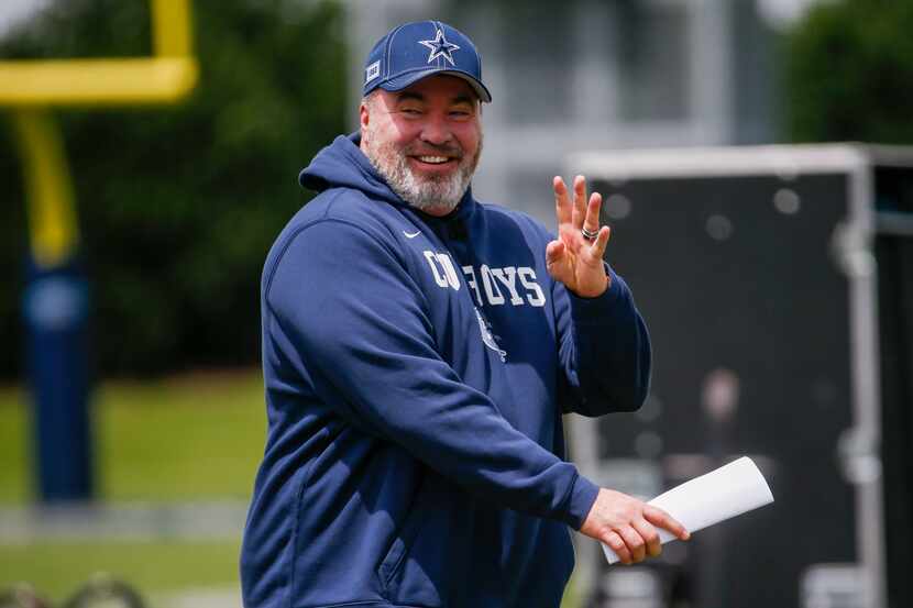 Dallas Cowboys coach Mike McCarthy walks back to the field during the Cowboys second OTA...