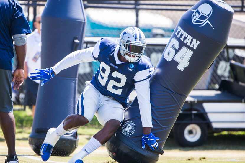 Dallas Cowboys defensive end Dorance Armstrong (92) attacks a dummy during a morning...