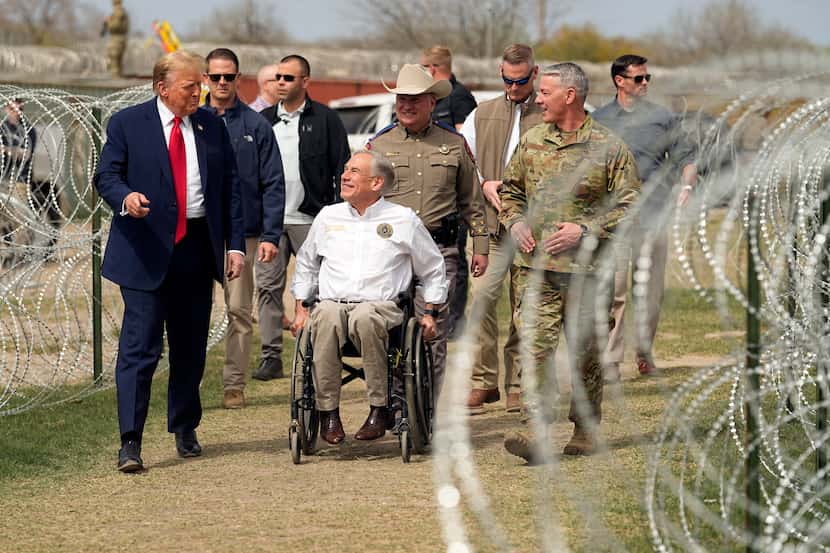 Republican presidential candidate Donald Trump talks with Texas Gov. Greg Abbott during a...
