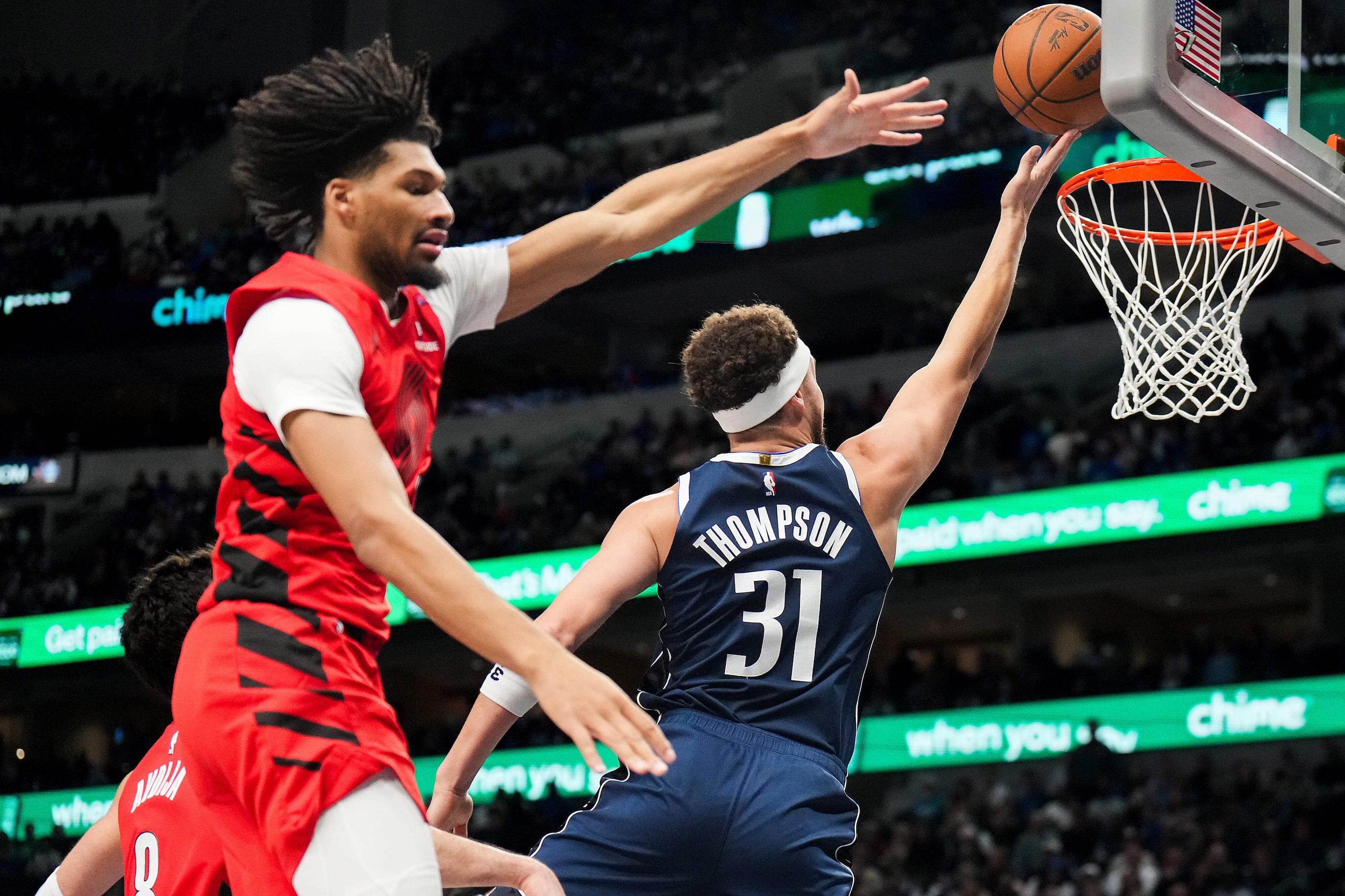 Dallas Mavericks guard Klay Thompson (31) scores past Portland Trail Blazers guard Shaedon...