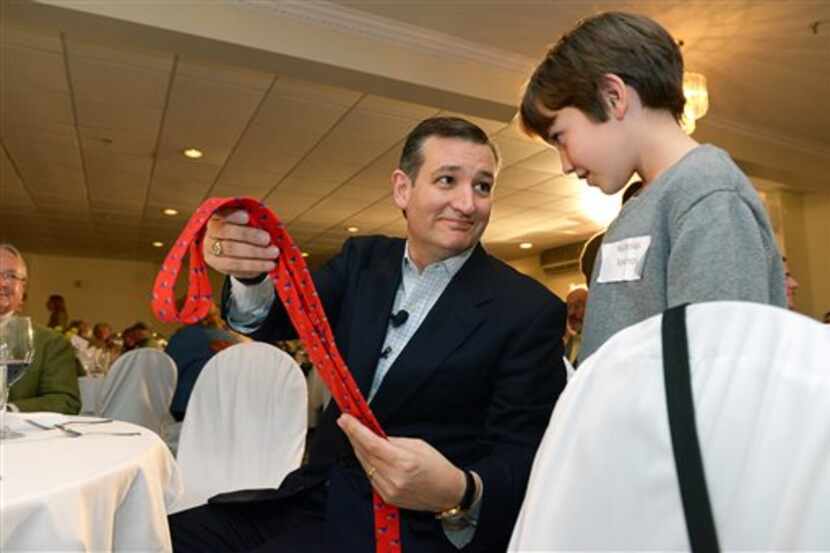  Sen. Ted Cruz presents 11-year-old Nicholas Spanos of Woodstock, N.H., with a signed tie...