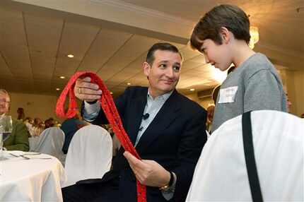  Sen. Ted Cruz presents 11-year-old Nicholas Spanos of Woodstock, N.H., with a signed tie...