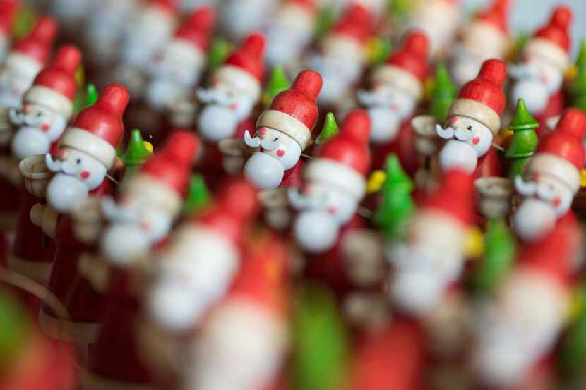 Wooden Santa Claus figurines stand in orderly rows at the paint shop of the Mueller Wood Art...