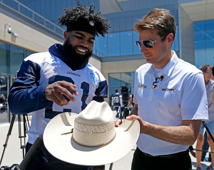 Indianapolis 500 winner Will Power, right, gives a cowboys hat to Dallas Cowboys running...