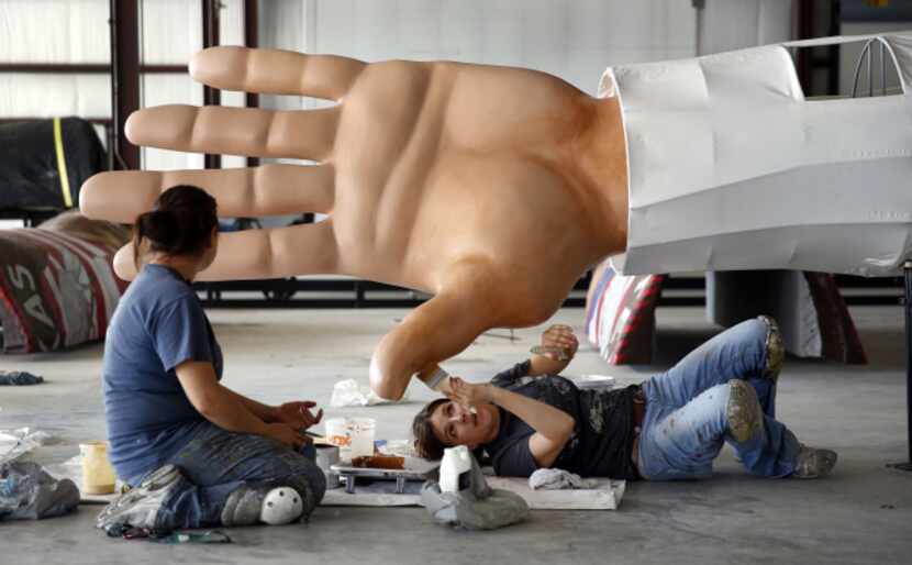 SRO scenic artist Amy Martin applied a coat of special silicone paint to Big Tex's left hand...