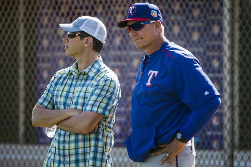 Texas Rangers General Manager Jon Daniels  watches a spring workout with manager Jeff...