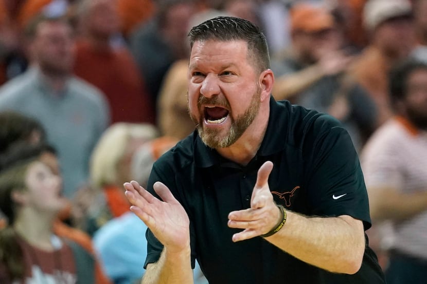 Texas coach Chris Beard talks to players during the first half of an NCAA college basketball...