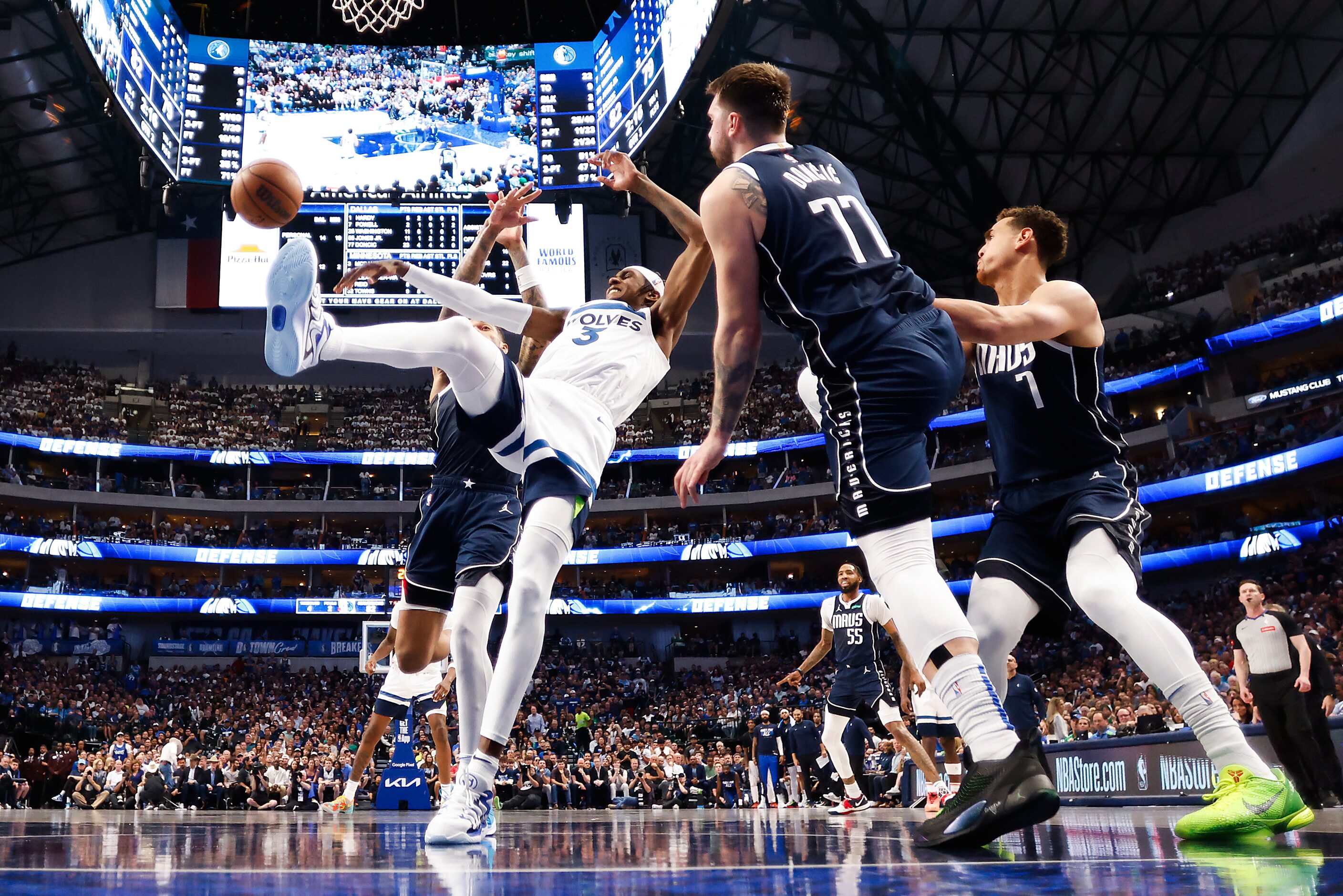 Minnesota Timberwolves forward Jaden McDaniels (3) is fouled by Dallas Mavericks guard Luka...