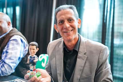 Nick Stavrou holds up a bobble-head of himself.