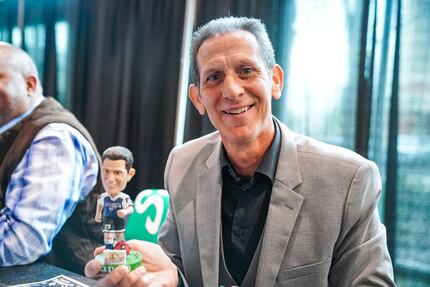 Nick Stavrou holds up a bobble-head of himself.