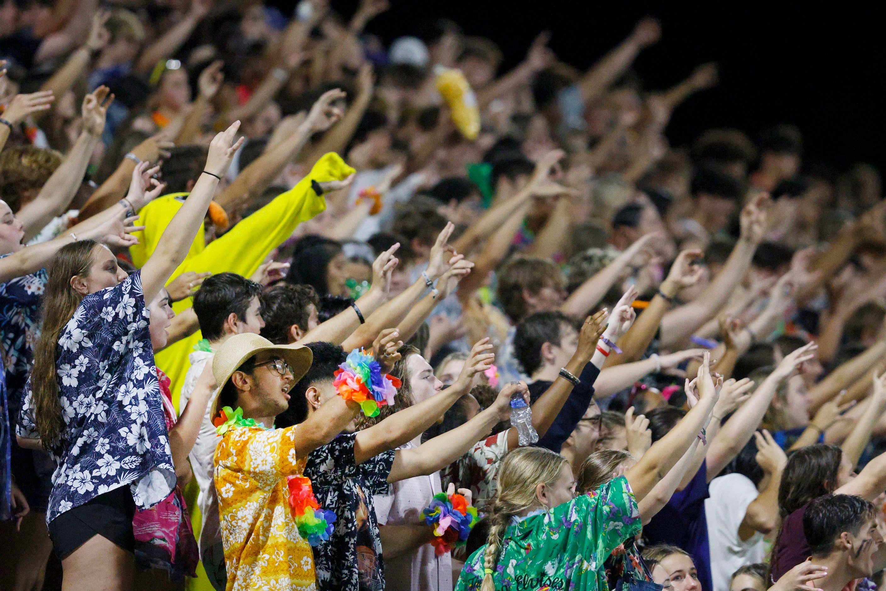 Byron Nelson's fans cheer during the second half of a high school football game against...