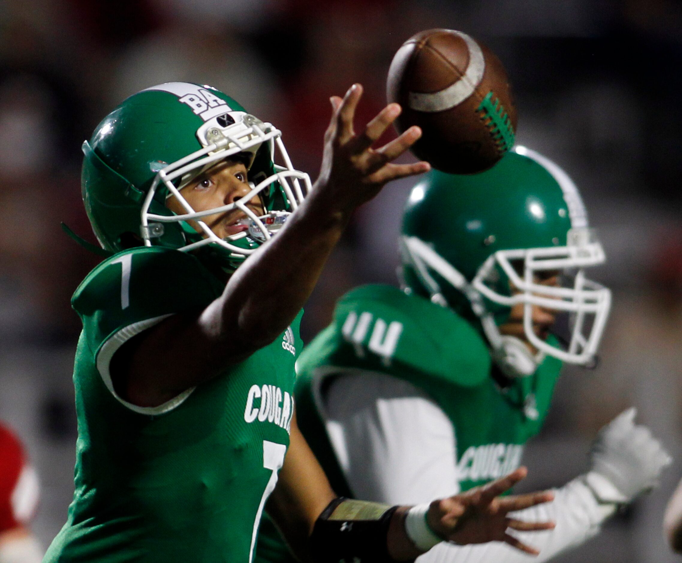 Dallas Bryan Adams quarterback Rayvon Jackson (7) reaches to pull in a wide snap from center...