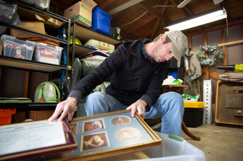 Travis Willoughby goes through a box of his mother, Monique Willoughby's belongings at his...