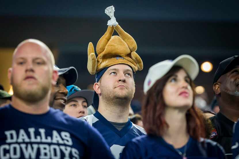 A Dallas Cowboys fan wears a turkey hat as he watches during the first quarter of an NFL...