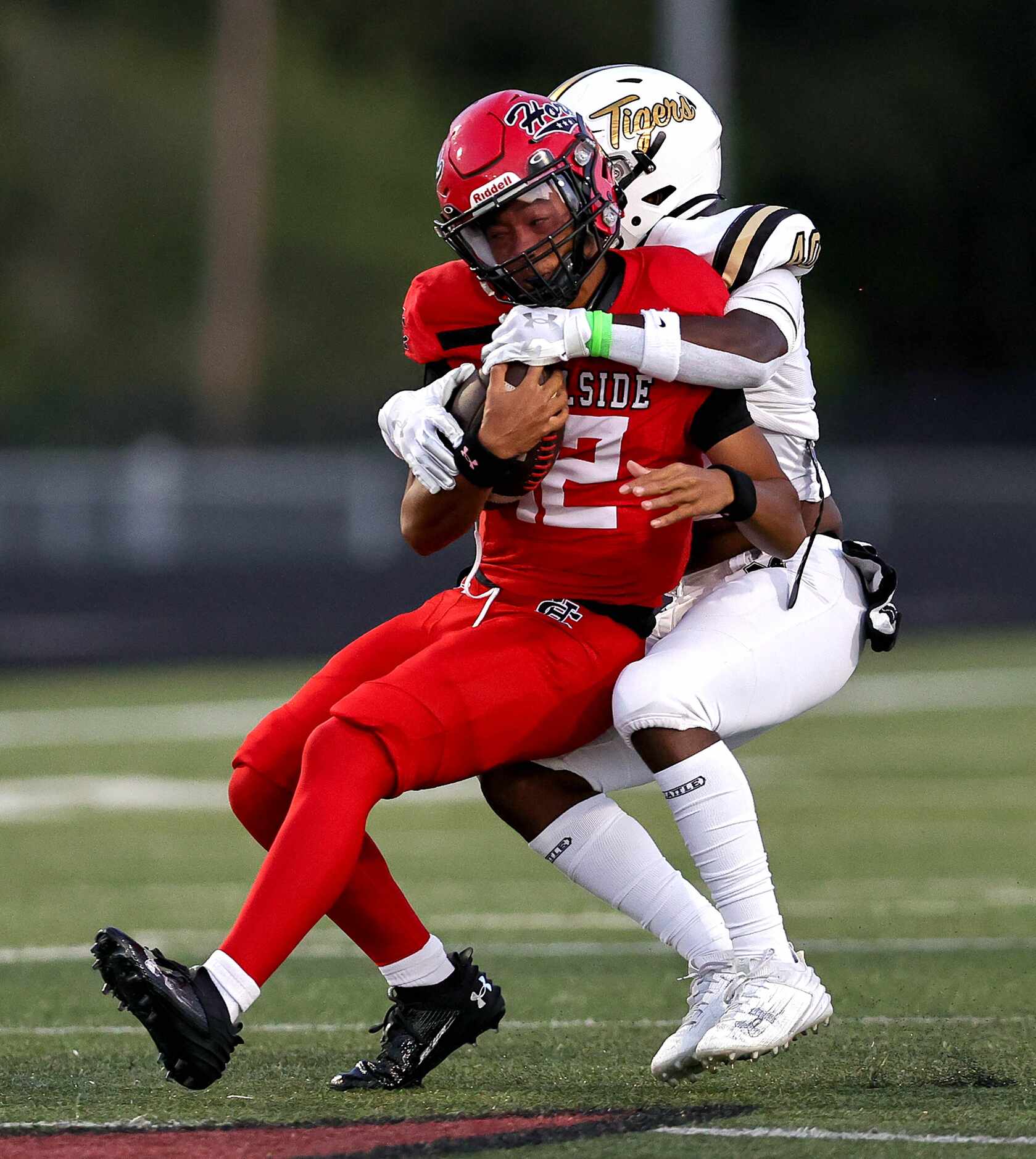 Cedar Hill quarterback Anthony Edwards (12) gets wrapped up by Mansfield defensive end Corey...