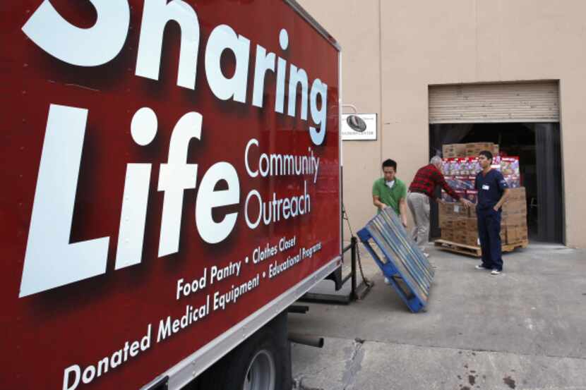 Workers unload food and diapers at Sharing Life Community Outreach.