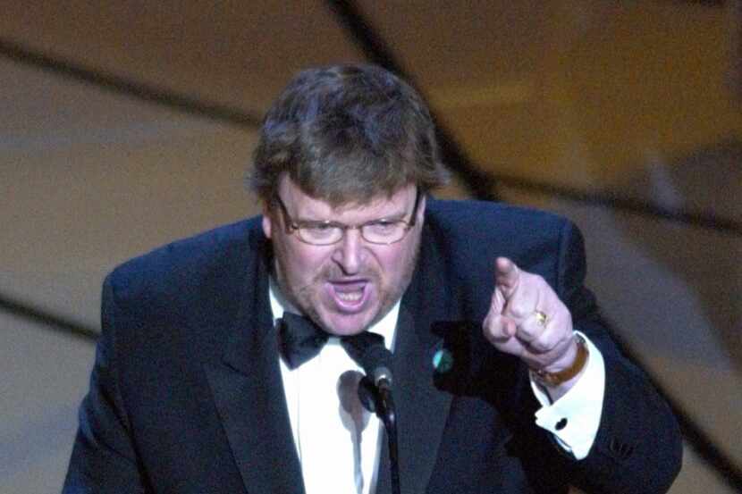 In this March 23, 2003, file photo, Michael Moore speaks out against President George W....