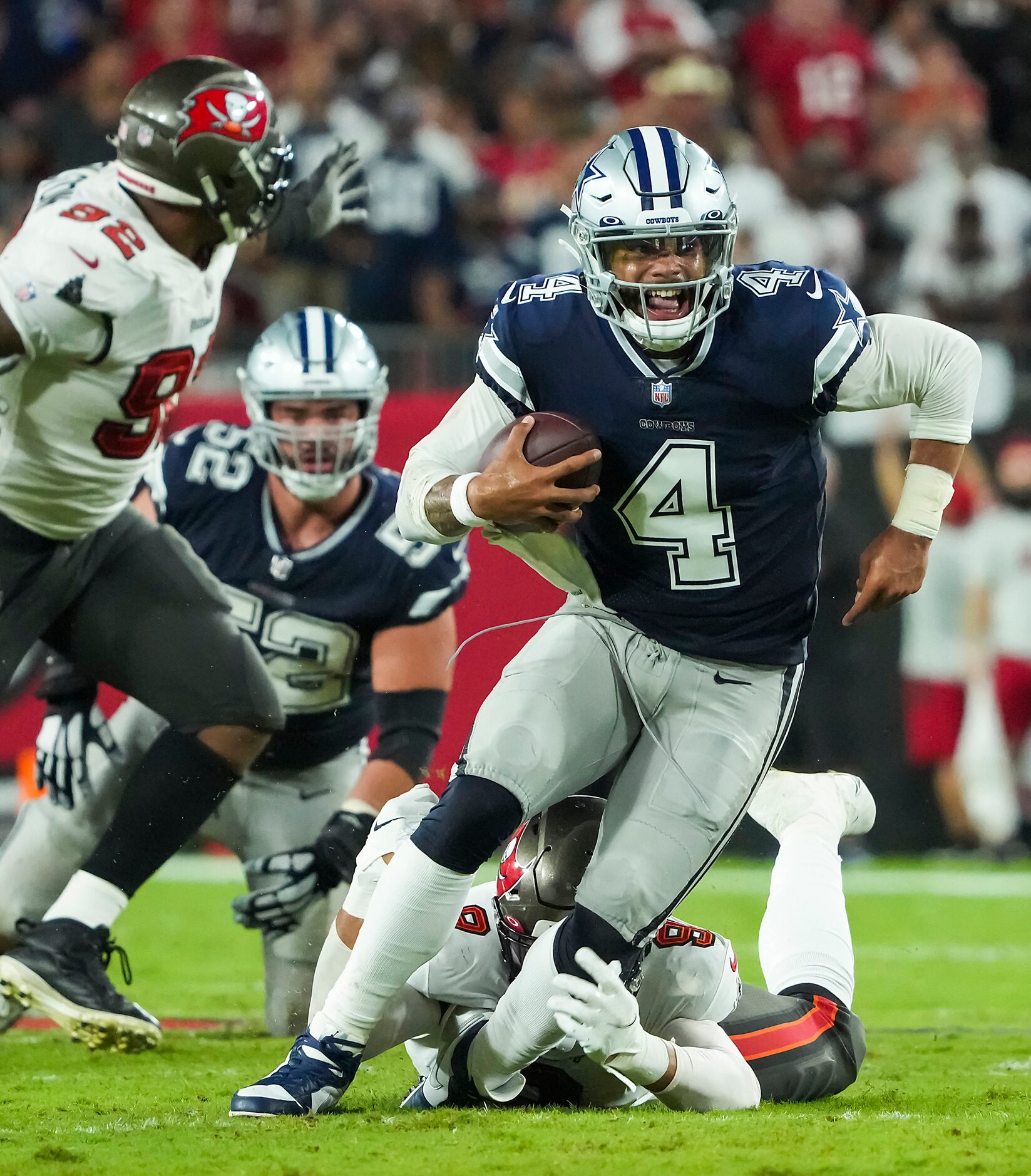 Dallas Cowboys quarterback Dak Prescott (4) is tripped up by Tampa Bay Buccaneers linebacker...